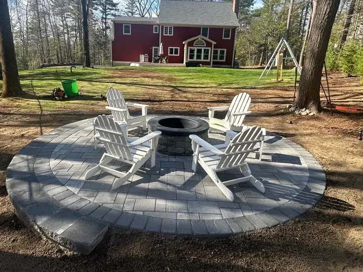 Round paver patio with a border band built around a fire pit