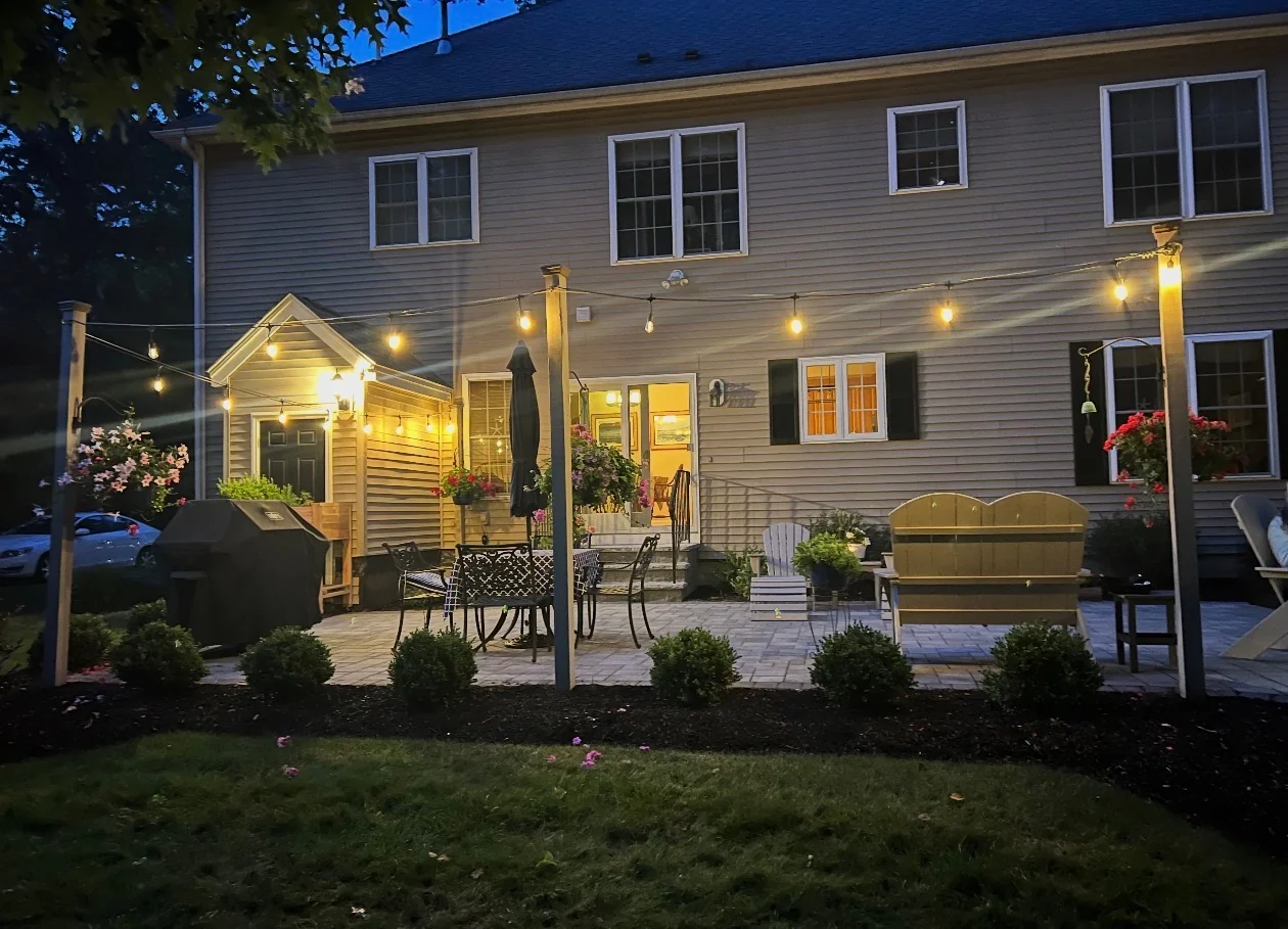 Twilight patio with a yellow bench built by Up North Scapes on the NH Seacoast
