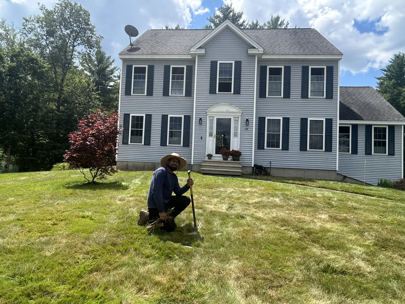 Up North Scapes crew member Camilo working on the Brentwood NH front yard