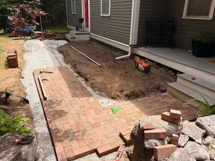 Brick walk half laid on its compacted gravel bed