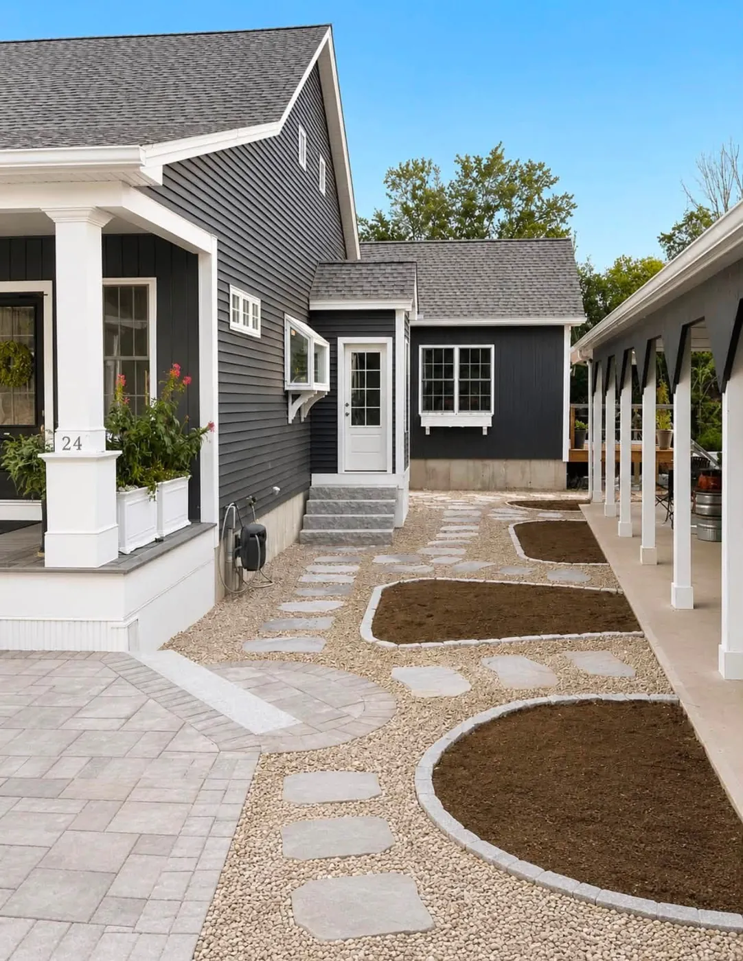 Flagstone steppers in pea gravel running along a long covered porch