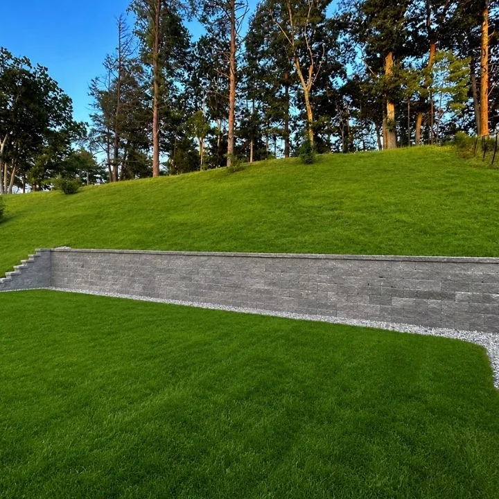 Structural block retaining wall holding a mown grass bank