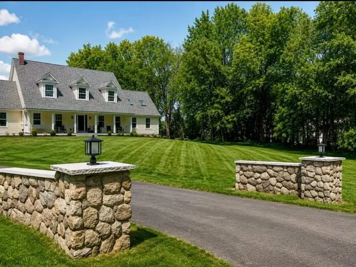 Fieldstone pillars and short walls at the end of a driveway