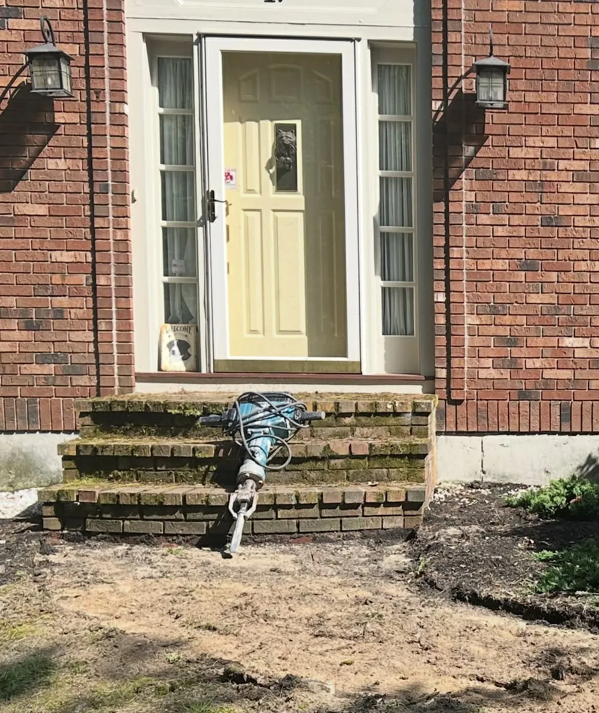 Old brick front steps being broken out