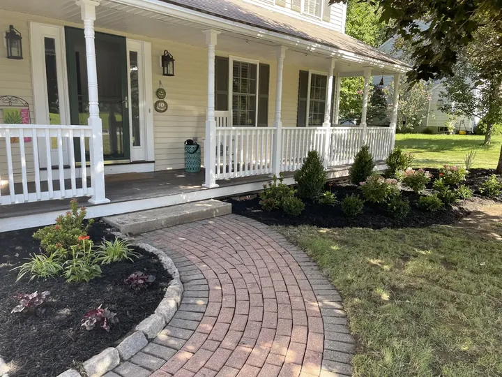 New front beds along a porch and a curved paver walk
