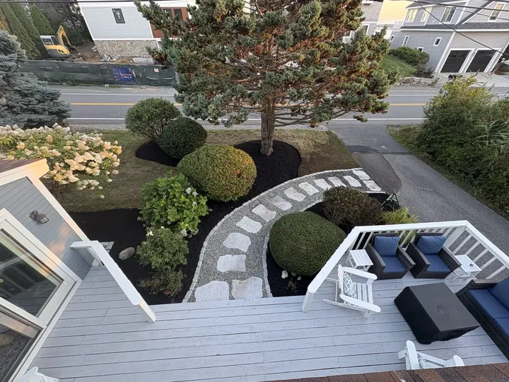 Mulched shrub beds seen from a deck above