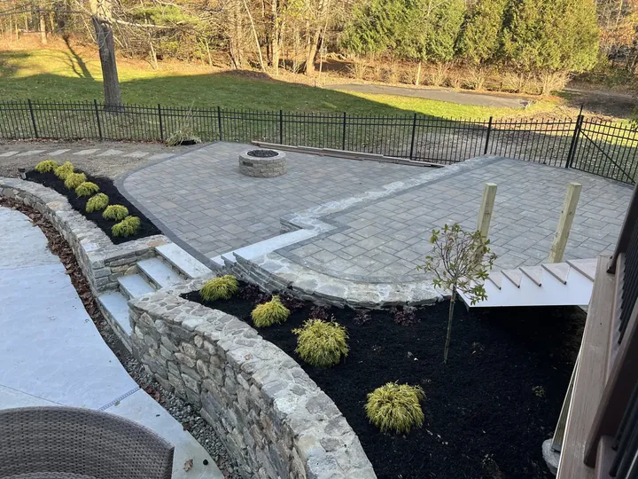 Low plantings along a curved patio wall