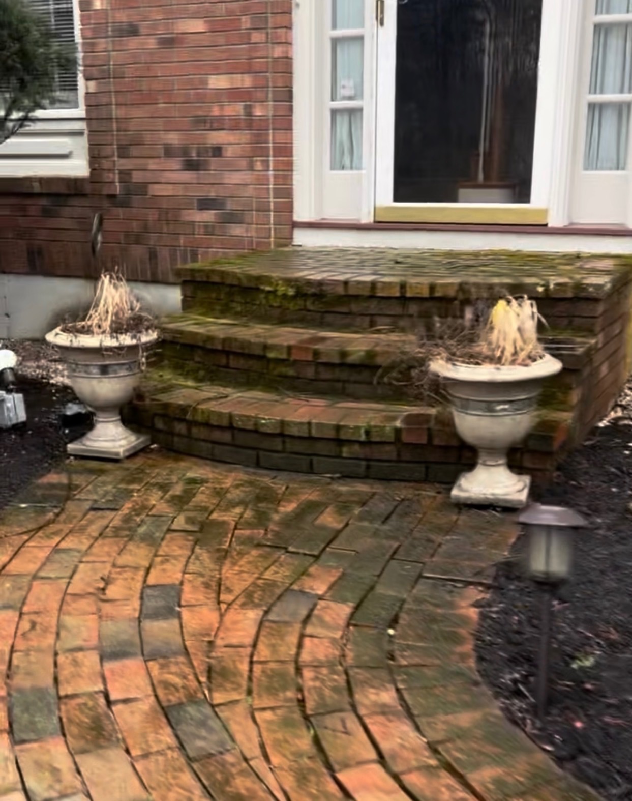 Cracked, settled brick walkway and steps before renovation
